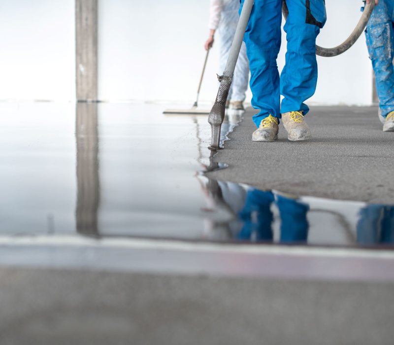 construction-workers-leveling-flooring-in-modern-b-2026-03-16-04-29-26-utc